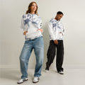 Leaky ts All-Over Leak Hoodie in white with bold chaos print, unisex cotton hoodie with eye-catching design.