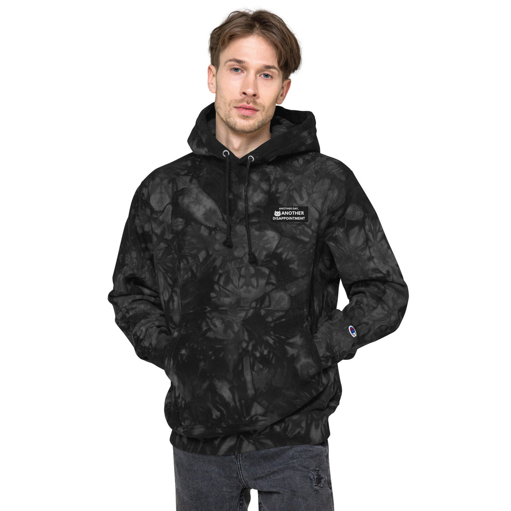 Unisex Champion Leak-Dye Hoodie by Leaky TS in black with vibrant tie-dye pattern on the front.