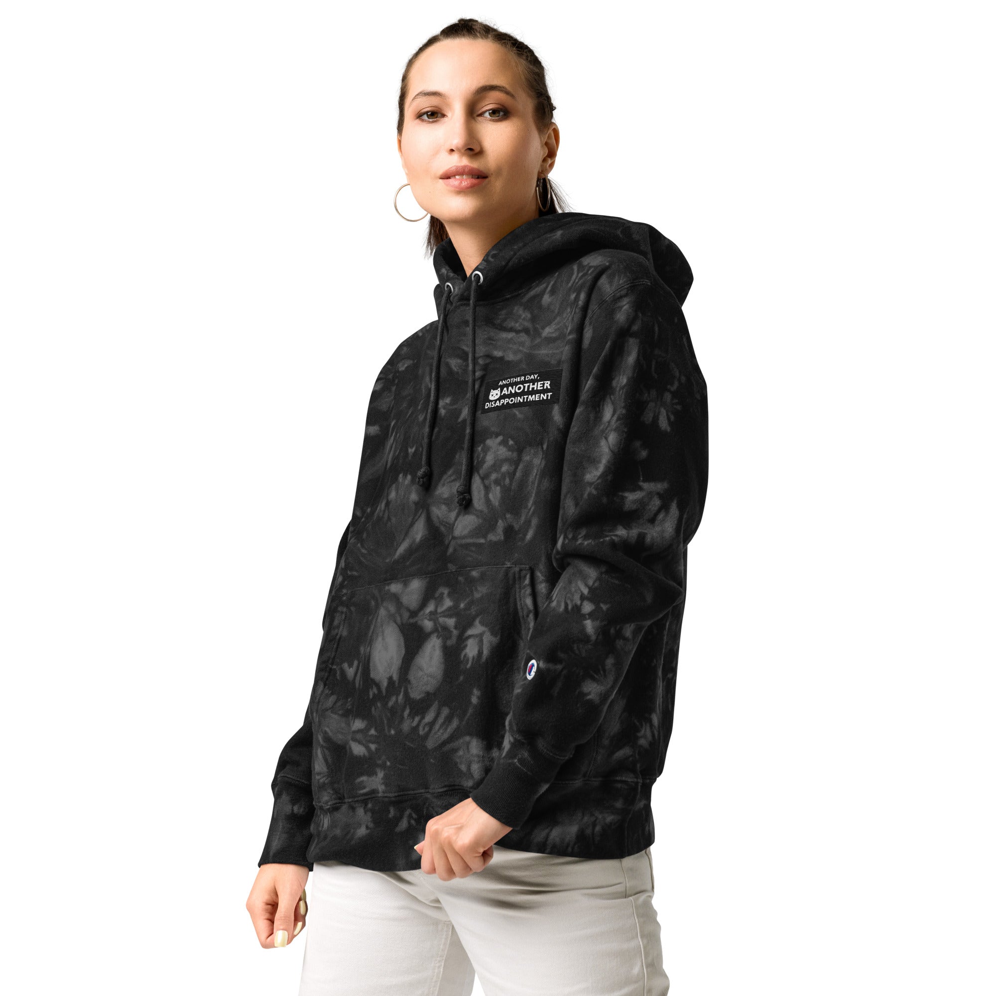 Unisex Champion Leak-Dye Hoodie by Leaky ts featuring a black tie-dye pattern and front pocket design.