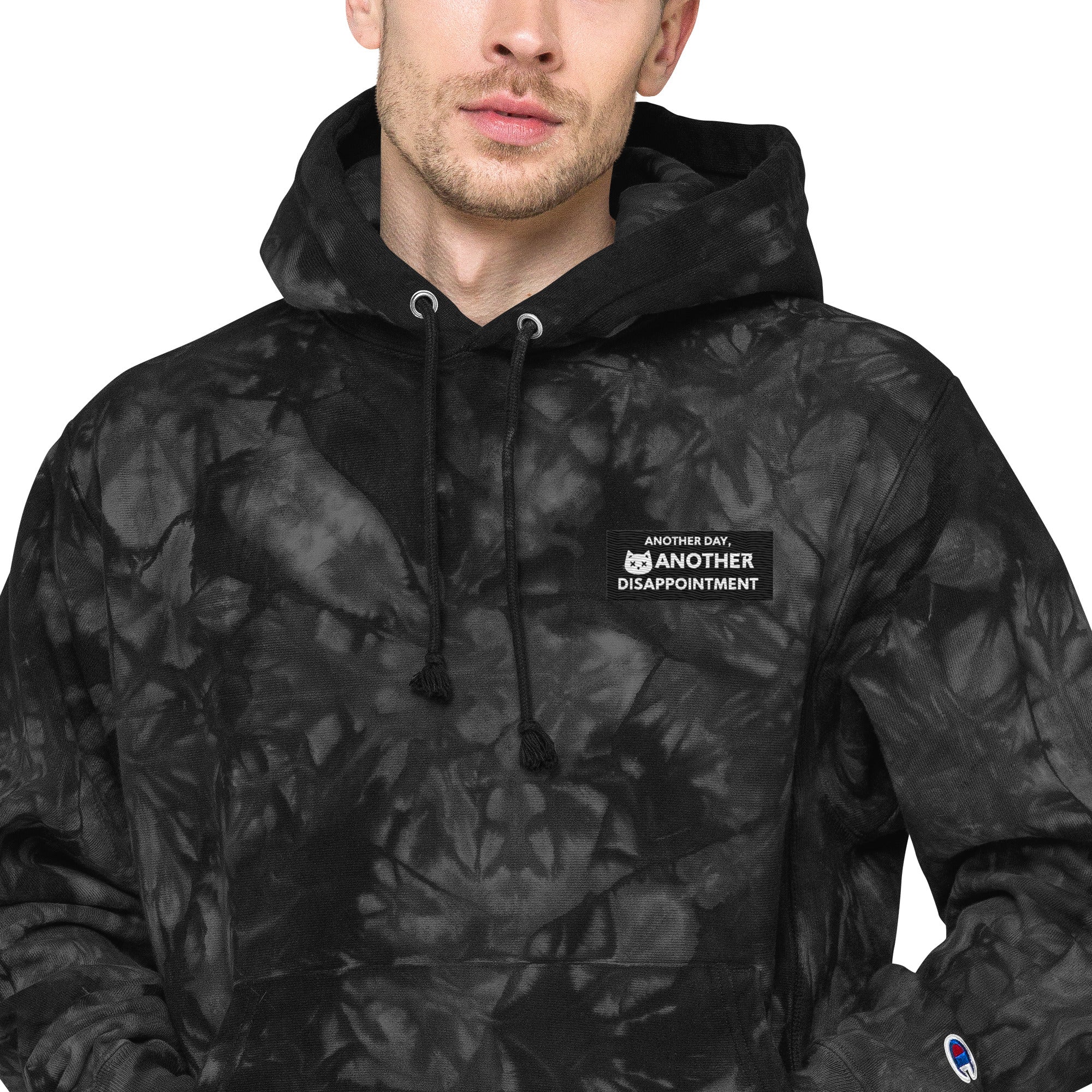Unisex Champion Leak-Dye Hoodie by Leaky ts in black with unique tie-dye pattern, close-up of fabric and design details.