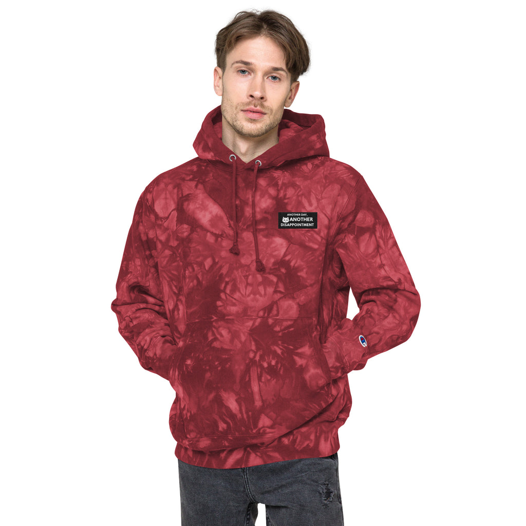 Unisex Champion Leak-Dye Hoodie in Mulled Berry with vibrant tie-dye pattern and front design, by Leaky ts.