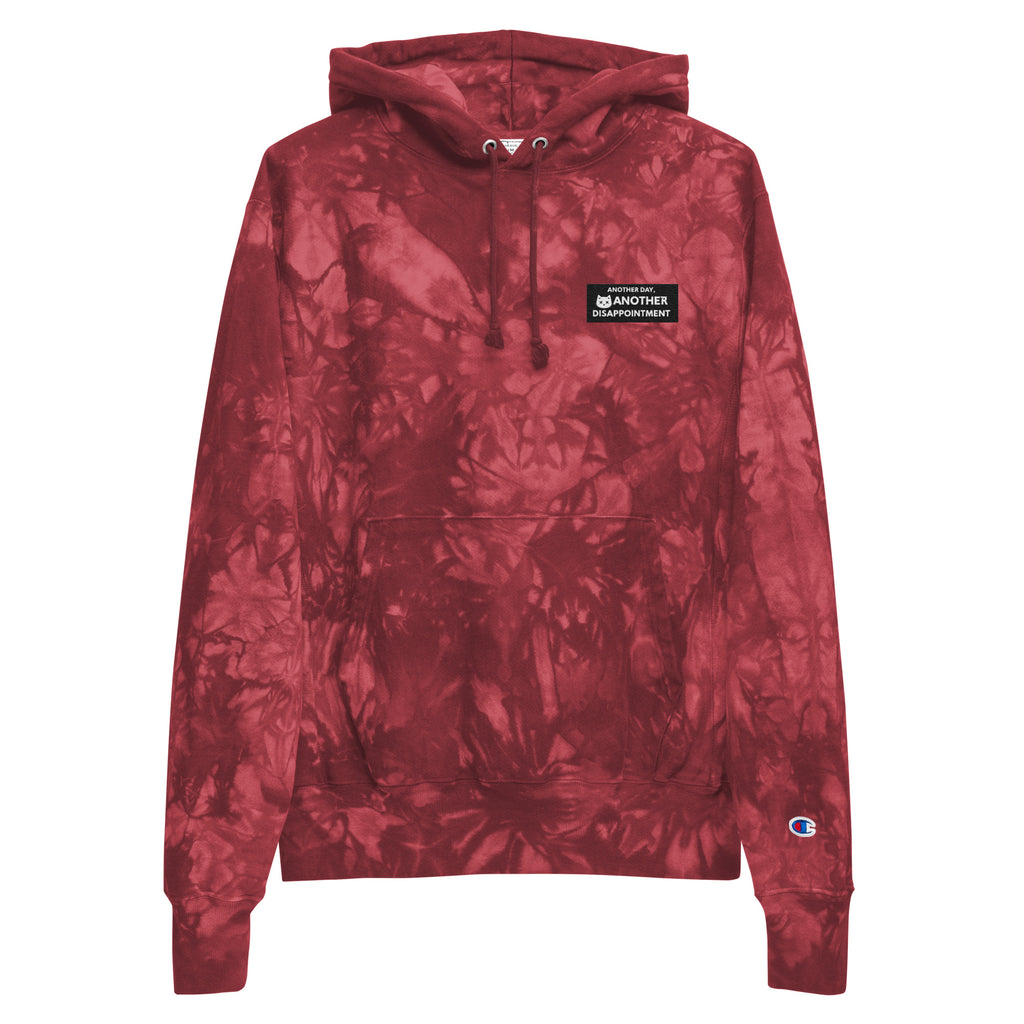 Leaky ts Champion leak-dye hoodie in mulled berry, unisex tie-dye design, front view showing vibrant, artistic pattern.