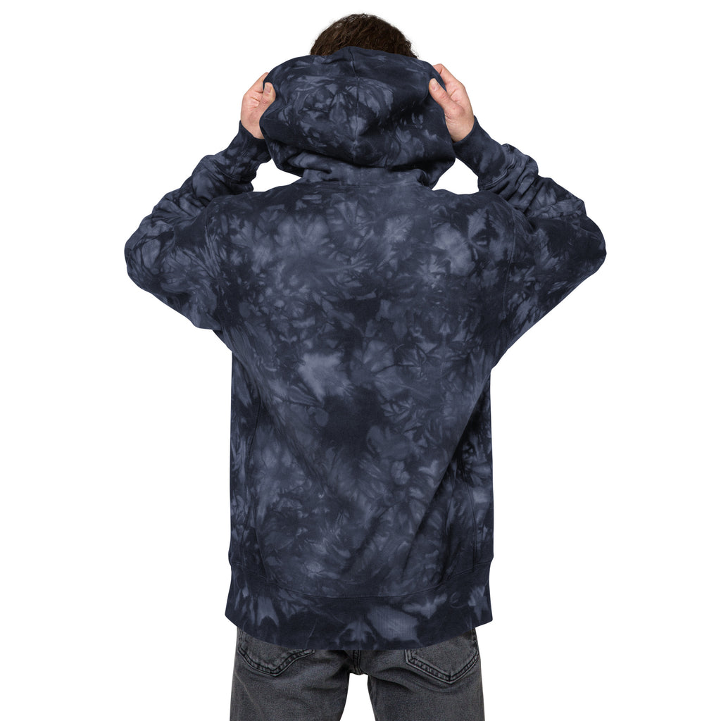 Unisex navy Champion Leak-Dye Hoodie by Leaky ts featuring a bold, unique leak-dye pattern on soft cotton fabric.