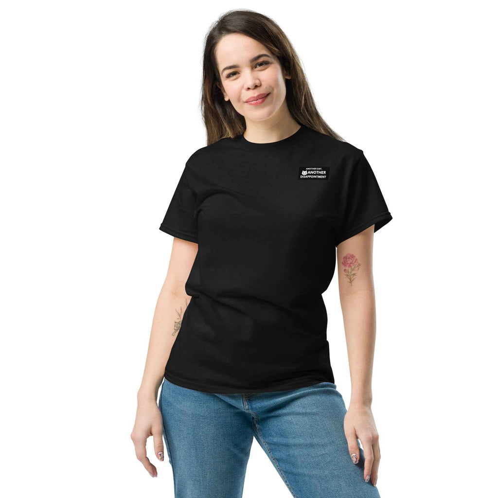 Black unisex classic tee by Leaky TS featuring a simple, comfortable design and a front graphic with the phrase "Another day another disappointment."