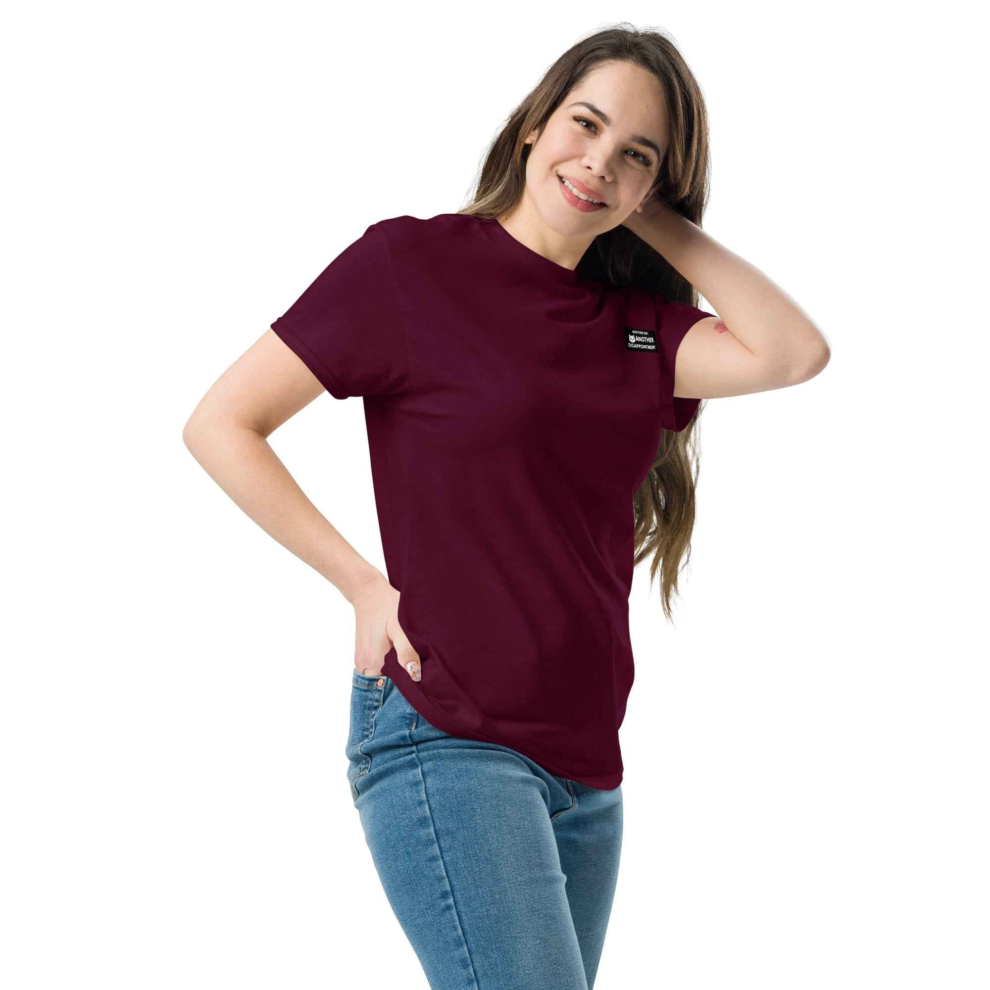 Maroon unisex classic tee by Leaky Ts, displayed from the front left side, showcasing a casual fit and soft fabric.