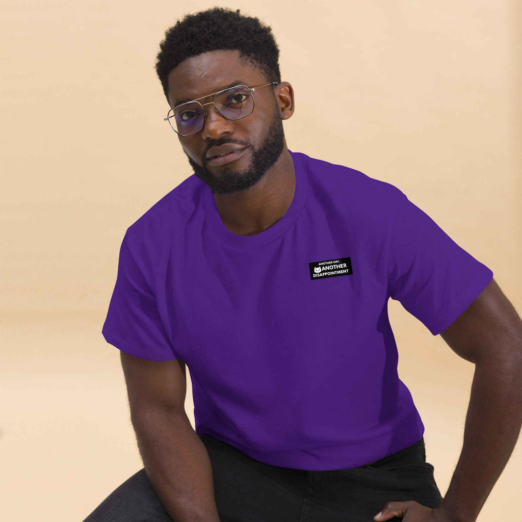 Purple unisex classic tee by Leaky TS featuring a simple, relaxed fit with "Another day another disappointment" slogan on the front.