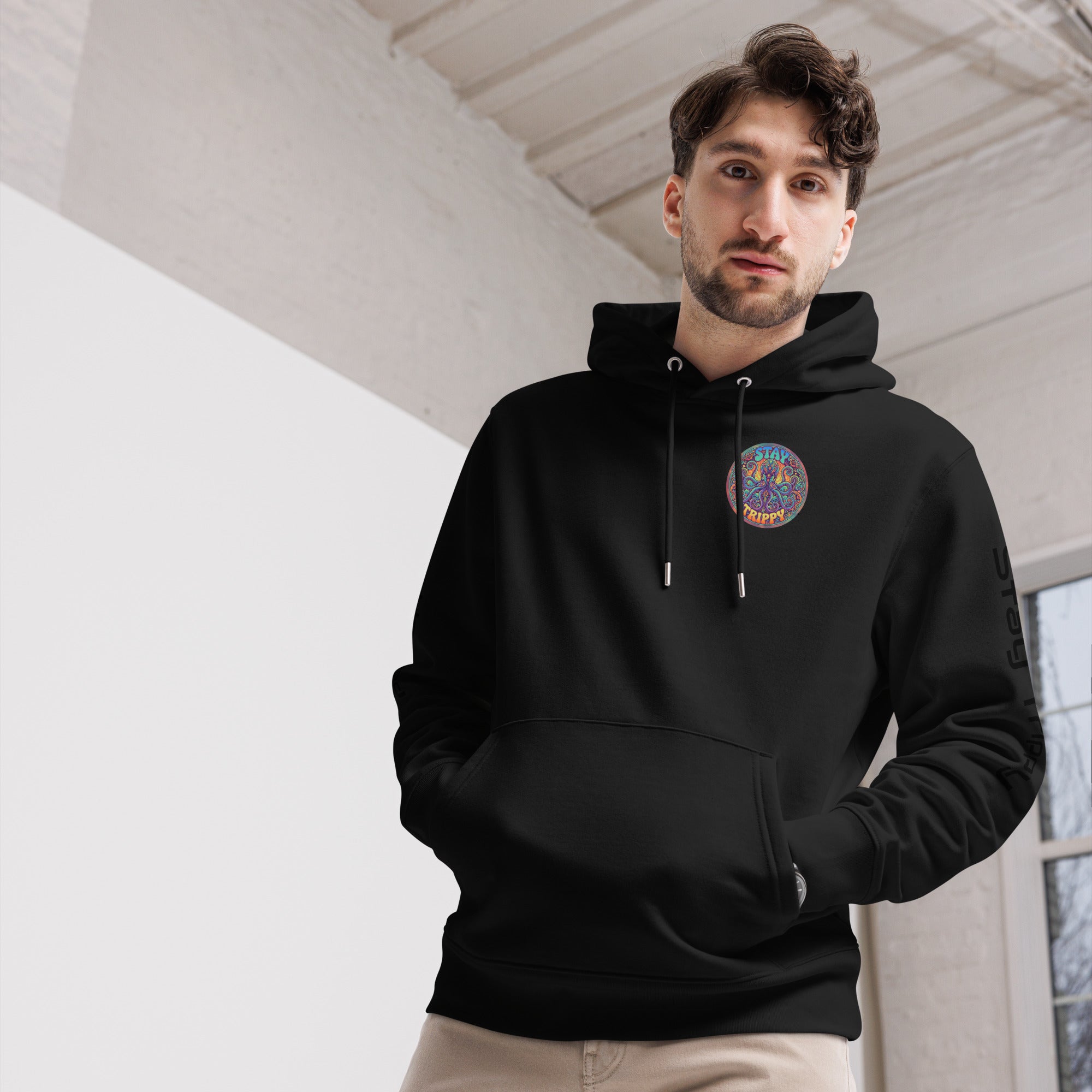Black Stay Trippy Hoodie by Leaky Ts, unisex organic cotton sweatshirt with front design, eco-friendly and comfortable.
