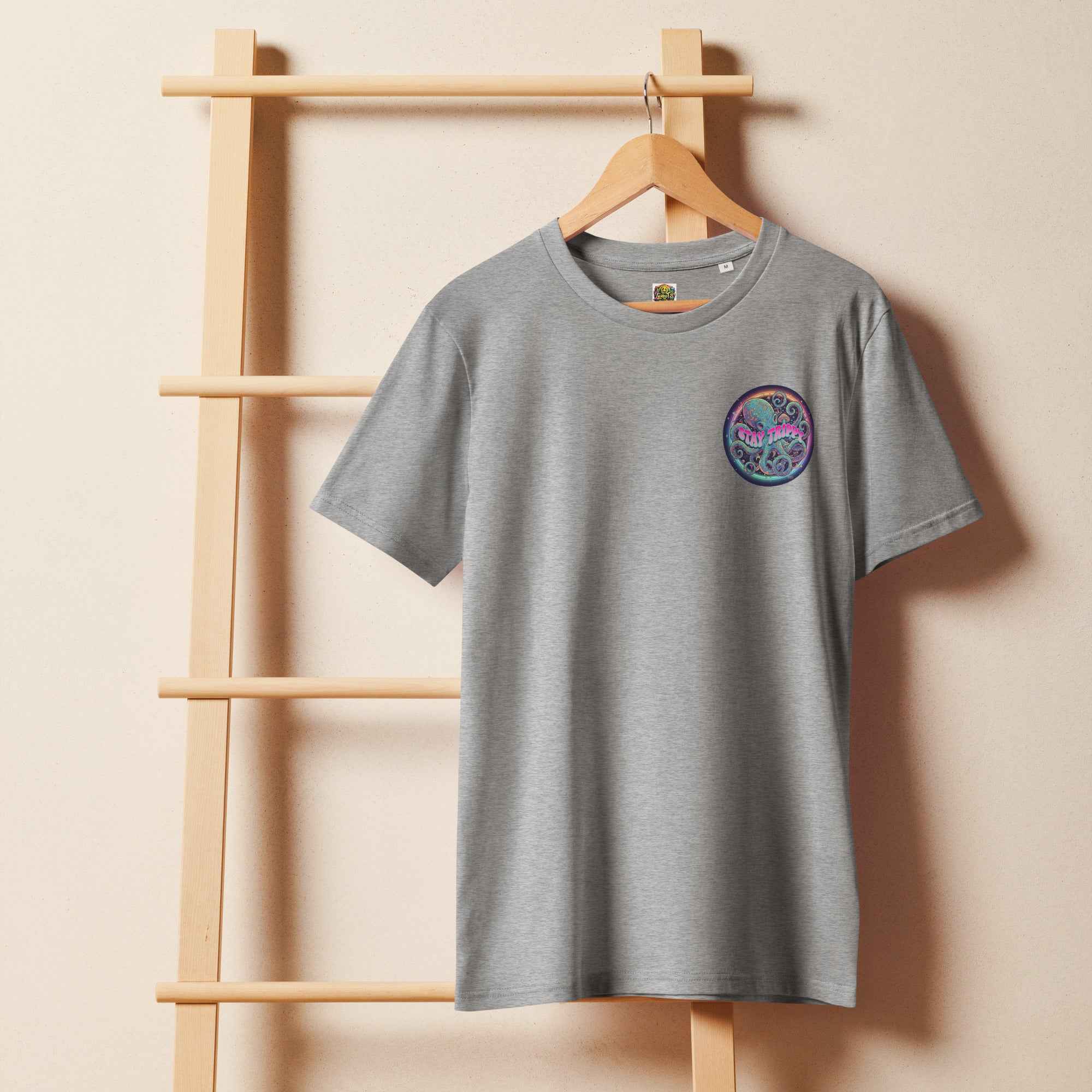 Unisex organic mid-light Heather Grey T-shirt with "Stay Trippy #2" graphic by Leaky TS, front view.
